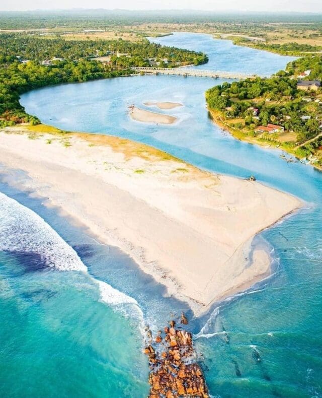 Tranquil Nilaveli Beach in Trincomalee with turquoise water and palm trees
